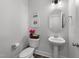 Stylish powder room with pedestal sink and decorative wall art at 283 Dry Canyon Dr, Wendell, NC 27591