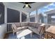 Inviting screened porch featuring a comfortable seating area with sectional sofa and a stylish blue rug at 283 Dry Canyon Dr, Wendell, NC 27591