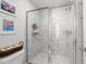 A tiled shower area showcasing decorative tile walls, glass door, and toiletry shelving at 283 Dry Canyon Dr, Wendell, NC 27591