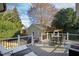 View of the spacious back deck with comfortable seating and a fire pit at 2920 Claremont Rd, Raleigh, NC 27608