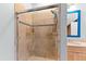 Shower with glass doors and tile surround, next to modern vanity at 2920 Claremont Rd, Raleigh, NC 27608
