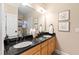 Bathroom featuring double sinks with black granite countertops and modern fixtures at 2920 Claremont Rd, Raleigh, NC 27608