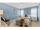 Charming bedroom featuring a decorative bed, unique artwork, and neutral carpet at 2920 Claremont Rd, Raleigh, NC 27608