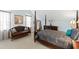 Bedroom featuring a four-poster bed, comfortable sofa, and ample natural light at 2920 Claremont Rd, Raleigh, NC 27608