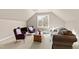 Cozy bonus room with comfortable seating, natural light, and neutral color scheme at 2920 Claremont Rd, Raleigh, NC 27608
