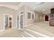 View of the bonus room featuring a neutral color palette, steps, and french doors at 2920 Claremont Rd, Raleigh, NC 27608