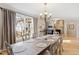 Dining room with chandelier lighting, hardwood floors, and a large window overlooking the yard at 2920 Claremont Rd, Raleigh, NC 27608
