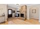 Entryway featuring a stone fireplace, hardwood floors, and a dark wood front door at 2920 Claremont Rd, Raleigh, NC 27608