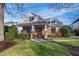 Charming stone and siding two-story home with a well-manicured front lawn and inviting curb appeal at 2920 Claremont Rd, Raleigh, NC 27608