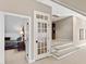 Hallway featuring a staircase and decorative glass door to another room at 2920 Claremont Rd, Raleigh, NC 27608
