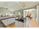 Spacious kitchen featuring an island cooktop, granite countertops, and a chandelier-lit dining area at 2920 Claremont Rd, Raleigh, NC 27608