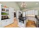 Open kitchen boasts granite countertops, stainless steel appliances, and white cabinets for ample storage at 2920 Claremont Rd, Raleigh, NC 27608