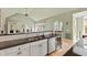 Elegant kitchen with light cabinets, stainless steel appliances, and an adjacent sunlit breakfast nook at 2920 Claremont Rd, Raleigh, NC 27608