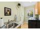 Laundry room with modern washer and dryer, and a utility sink with granite countertop at 2920 Claremont Rd, Raleigh, NC 27608