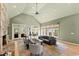 Open living room featuring vaulted ceilings, fireplace, and plenty of natural light at 2920 Claremont Rd, Raleigh, NC 27608