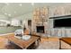 Cozy living room with a stone fireplace and built-in cabinets, perfect for relaxation at 2920 Claremont Rd, Raleigh, NC 27608