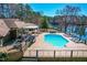 Aerial view of backyard featuring an in-ground pool, lounge area, and lake views with mature trees at 3021 Allenby Dr, Raleigh, NC 27604