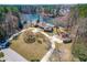 Stunning aerial view of a lakeside estate with lush landscaping, a pool, and a private driveway at 3021 Allenby Dr, Raleigh, NC 27604