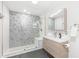Bathroom featuring sleek vanity, modern fixtures and a walk-in shower with decorative tile at 3021 Allenby Dr, Raleigh, NC 27604