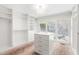 Spacious walk-in closet featuring built-in storage, a central island, and natural light at 3021 Allenby Dr, Raleigh, NC 27604