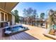 Deck with a hot tub overlooking a lake and lush greenery, perfect for relaxation at 3021 Allenby Dr, Raleigh, NC 27604