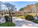 A gated circular driveway leads to this spacious property with lush lawn and mature trees at 3021 Allenby Dr, Raleigh, NC 27604