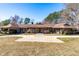 Sprawling home features beautiful stone accents, mature trees, and a circular driveway at 3021 Allenby Dr, Raleigh, NC 27604