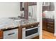 Close-up of the kitchen island with granite countertop, built-in microwave and refrigeration system at 3021 Allenby Dr, Raleigh, NC 27604