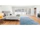 Sun-filled main bedroom featuring wood floors, a large window, and white bedding at 3021 Allenby Dr, Raleigh, NC 27604