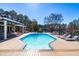 Inviting backyard pool with lounge chairs and views of the lake create a serene outdoor oasis at 3021 Allenby Dr, Raleigh, NC 27604