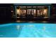 Enjoy the ambiance of this sparkling pool at night with the doors open to the covered porch at 3021 Allenby Dr, Raleigh, NC 27604