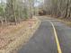 Well-maintained asphalt trail perfect for walking, biking, or jogging in a scenic natural setting at 3021 Allenby Dr, Raleigh, NC 27604