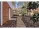 Backyard with a brick wall and a small shed with a chain link fence at 330 Wesley Dr, Chapel Hill, NC 27516
