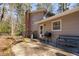 Backyard patio featuring a BBQ grill, bench, and outdoor seating with convenient access to the home at 330 Wesley Dr, Chapel Hill, NC 27516