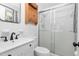 Updated bathroom with white fixtures, vanity, and a shower with glass doors at 330 Wesley Dr, Chapel Hill, NC 27516