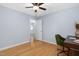 Bedroom with hardwood floors, light blue walls and ceiling fan, and a view to another room at 330 Wesley Dr, Chapel Hill, NC 27516