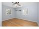 Bedroom with wood floors, light blue walls, two windows, and floating shelves at 330 Wesley Dr, Chapel Hill, NC 27516