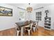 Cozy dining area filled with natural light, showcasing a stylish pendant light and hardwood flooring at 330 Wesley Dr, Chapel Hill, NC 27516