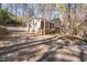 Charming home features brick accents, mature trees, and a long driveway at 330 Wesley Dr, Chapel Hill, NC 27516