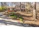 Two-story brick home with black shutters, surrounded by mature trees and greenery at 330 Wesley Dr, Chapel Hill, NC 27516
