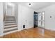 Inviting foyer featuring hardwood flooring, staircase, and a stylish front door at 330 Wesley Dr, Chapel Hill, NC 27516