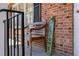 Inviting front porch with a rustic wooden bench and decorative 'Welcome' sign, set against a brick facade at 330 Wesley Dr, Chapel Hill, NC 27516