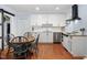 Bright kitchen features white cabinetry, stainless steel appliances, and a charming dining area at 330 Wesley Dr, Chapel Hill, NC 27516