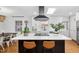 Bright kitchen features a large island with seating, modern appliances, and an eye-catching range hood at 330 Wesley Dr, Chapel Hill, NC 27516