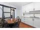 Bright kitchen features white cabinetry and a charming dining area with a sliding barn door at 330 Wesley Dr, Chapel Hill, NC 27516