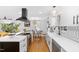 Bright, open kitchen featuring stainless steel appliances, an island cooktop, and updated white cabinetry at 330 Wesley Dr, Chapel Hill, NC 27516