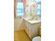 Retro yellow bathroom with classic tile work, vanity, and decorative butterfly accents at 3359 Huffines Dr, Burlington, NC 27217