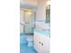Retro bathroom featuring blue tile, sink, and bathtub with sliding glass shower door at 3359 Huffines Dr, Burlington, NC 27217