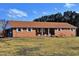 Charming brick ranch-style home with white shutters and a well-maintained front lawn on a sunny day at 3359 Huffines Dr, Burlington, NC 27217