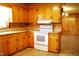 Well-lit kitchen featuring wooden cabinets, ample counter space, and modern white appliances at 3359 Huffines Dr, Burlington, NC 27217